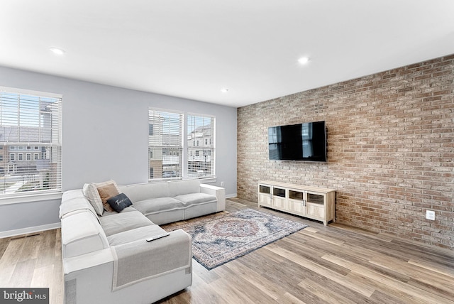 living room featuring baseboards, plenty of natural light, and light wood finished floors