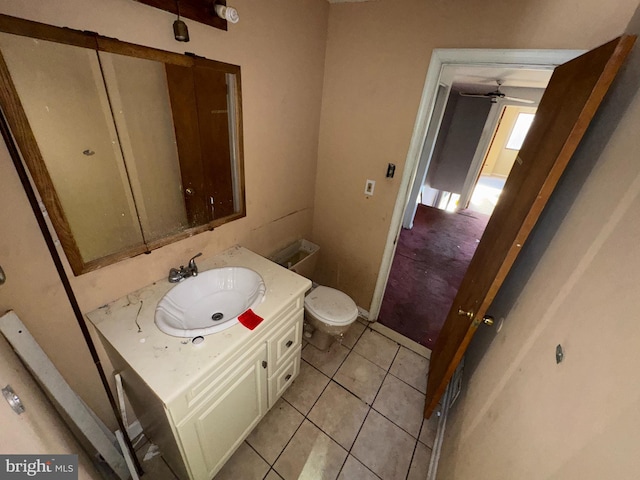 bathroom featuring vanity, tile patterned floors, and toilet