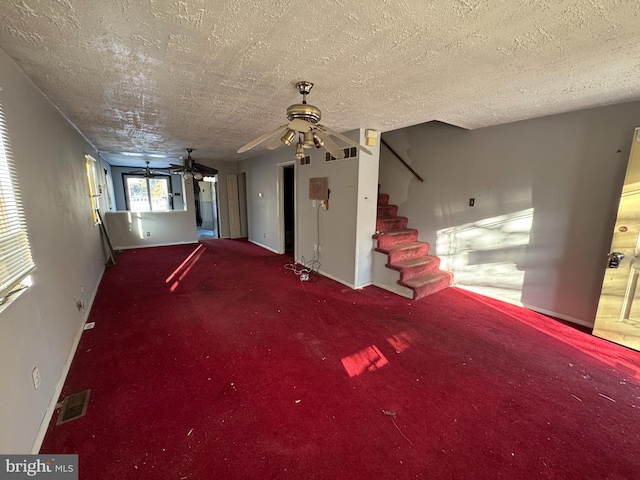 interior space featuring carpet flooring and a textured ceiling