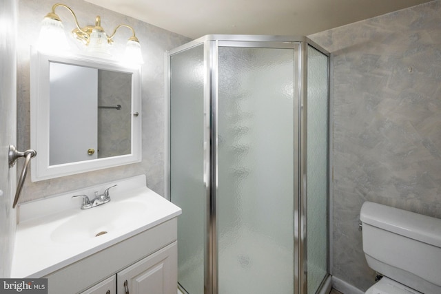 bathroom with walk in shower, vanity, and toilet