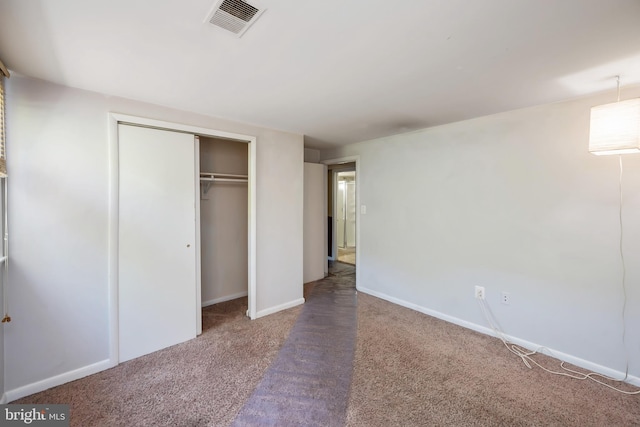 unfurnished bedroom with carpet flooring and a closet