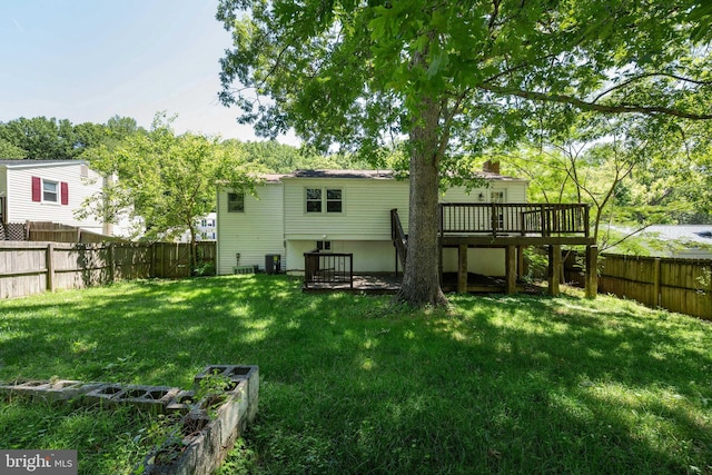 back of house featuring cooling unit, a yard, and a deck