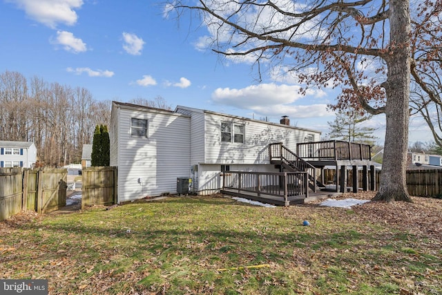 back of house with a lawn, a deck, and central air condition unit