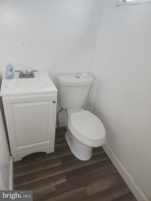 bathroom featuring hardwood / wood-style flooring, vanity, and toilet