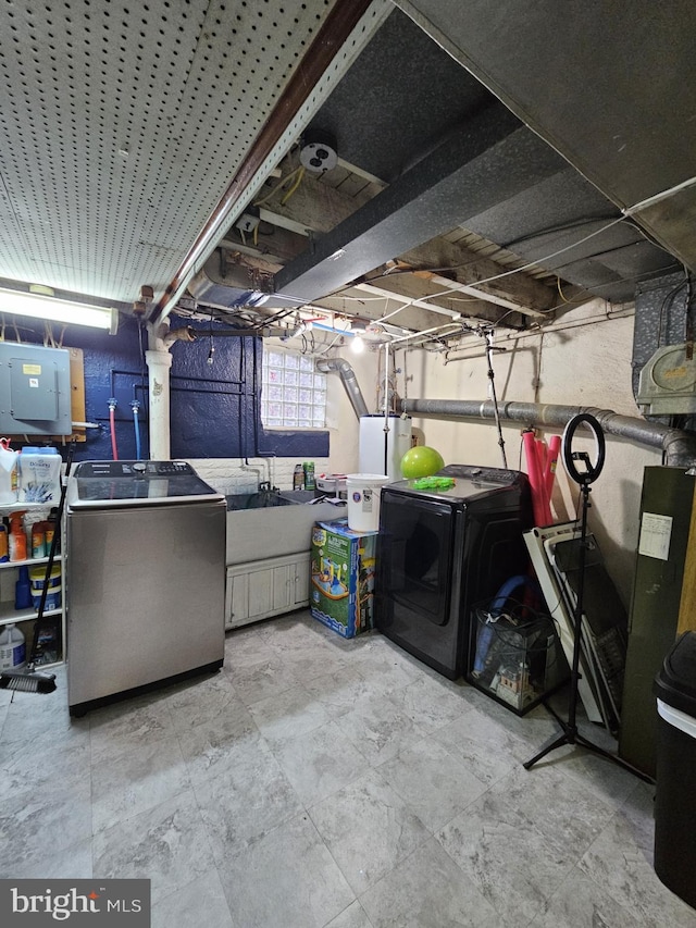 basement with electric panel and washer and clothes dryer