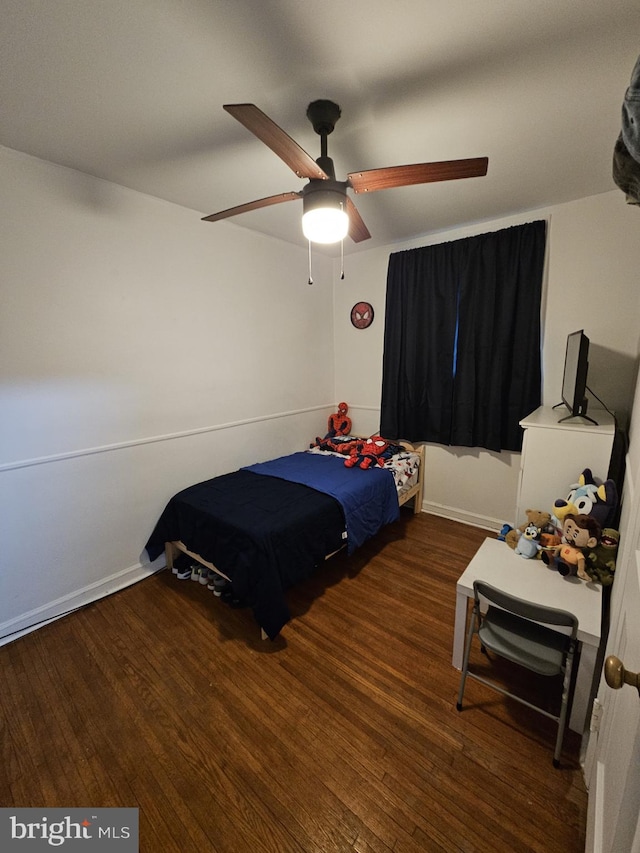 bedroom with ceiling fan and dark hardwood / wood-style flooring