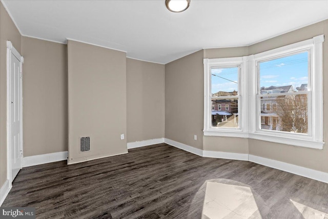 spare room with dark hardwood / wood-style floors