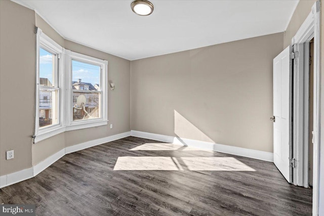 unfurnished room featuring dark wood-type flooring