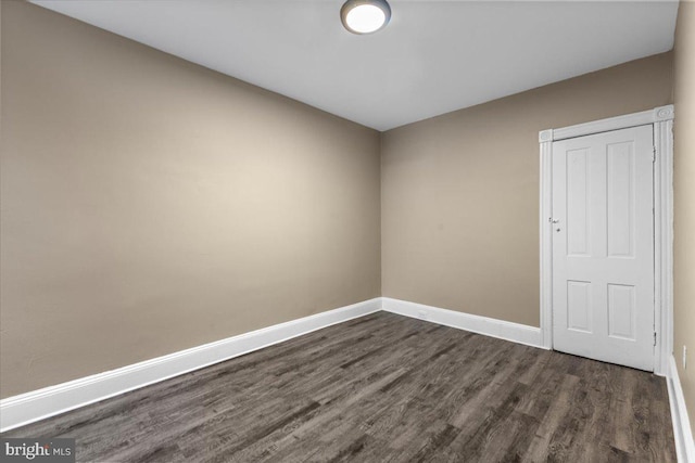 unfurnished room featuring dark hardwood / wood-style flooring