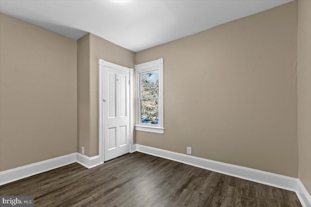 empty room with dark hardwood / wood-style floors