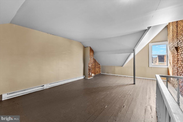 additional living space with hardwood / wood-style floors, vaulted ceiling, and baseboard heating