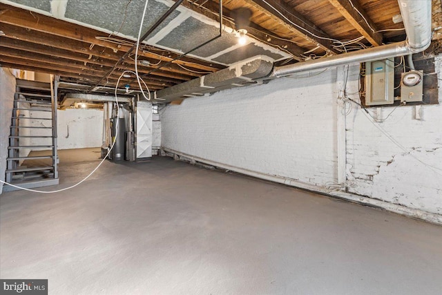 basement with water heater, heating unit, and electric panel