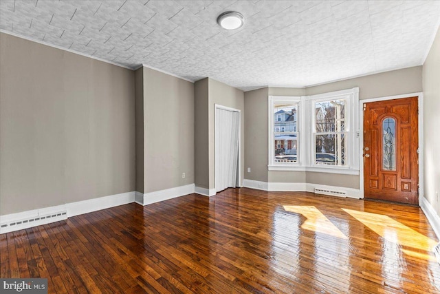 foyer featuring a baseboard heating unit and wood-type flooring