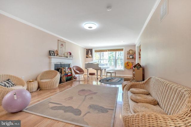 living area featuring crown molding and wood-type flooring