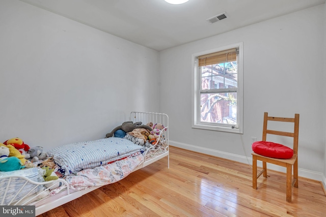 bedroom with wood-type flooring