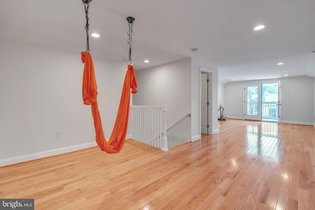 empty room featuring lofted ceiling and light wood-type flooring