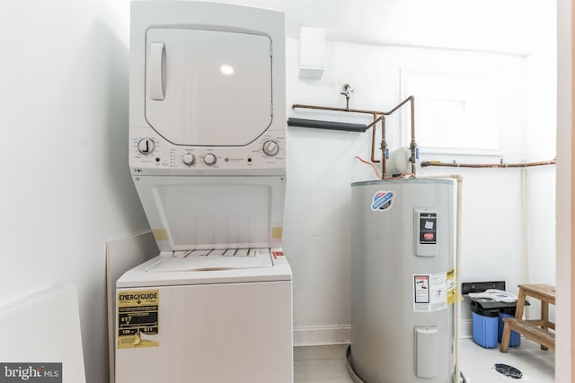 clothes washing area with electric water heater and stacked washing maching and dryer