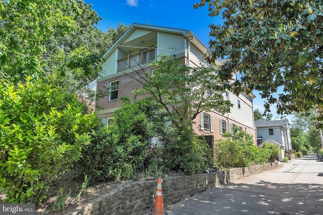 view of side of home featuring a balcony