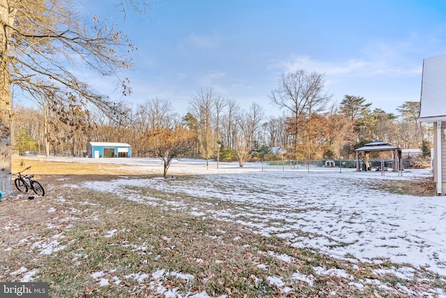 snowy yard featuring a gazebo