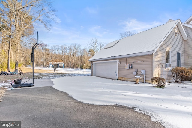 snow covered property featuring a garage