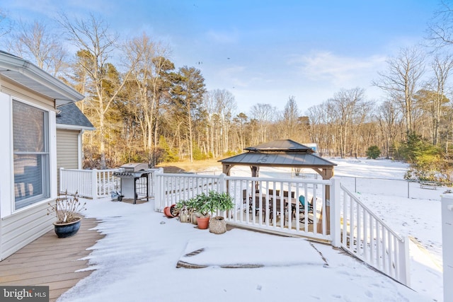 snow covered deck with a gazebo and grilling area