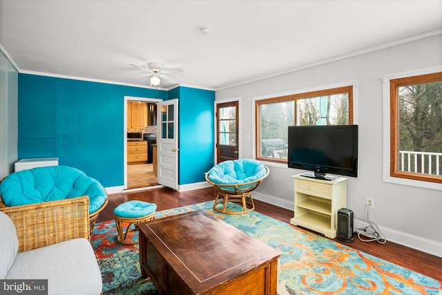 living room with crown molding, plenty of natural light, and dark hardwood / wood-style flooring