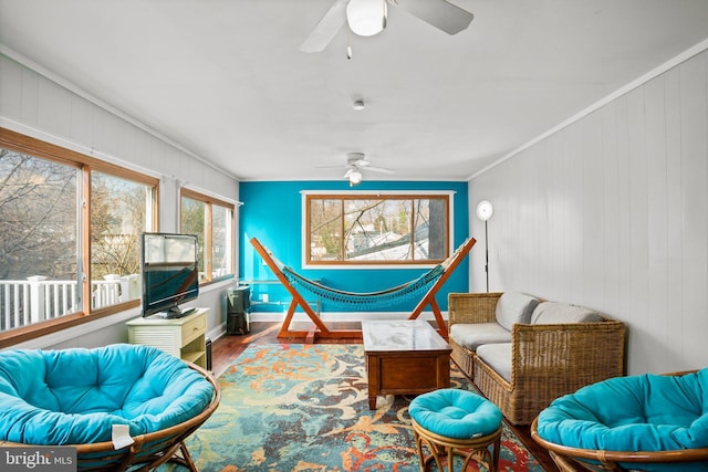 sitting room with ornamental molding, plenty of natural light, hardwood / wood-style floors, and ceiling fan