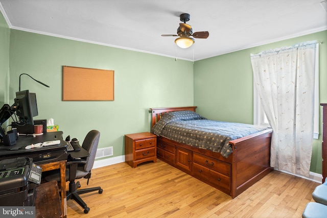 bedroom featuring ornamental molding, ceiling fan, and light hardwood / wood-style flooring