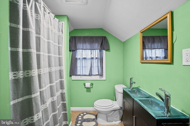 bathroom featuring vaulted ceiling, vanity, toilet, tile patterned floors, and a shower with shower curtain