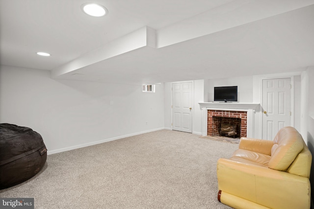 interior space with a brick fireplace and carpet flooring