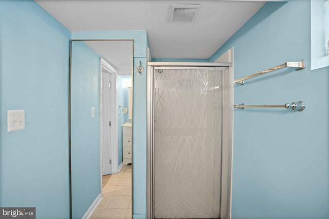 bathroom featuring tile patterned flooring and walk in shower