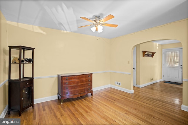 empty room with hardwood / wood-style flooring and ceiling fan