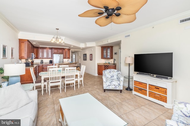 tiled living room with crown molding and ceiling fan with notable chandelier