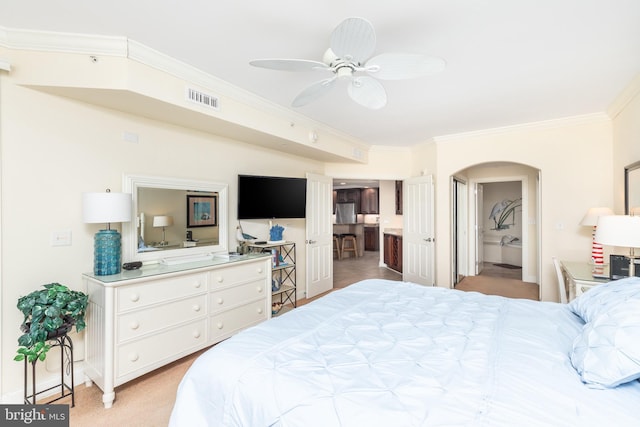 carpeted bedroom with crown molding and connected bathroom