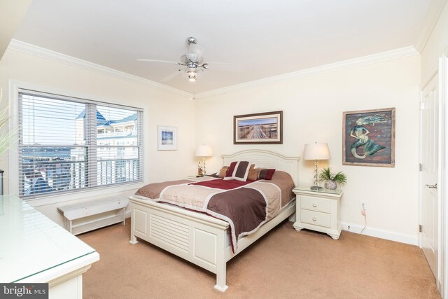 carpeted bedroom featuring crown molding and ceiling fan