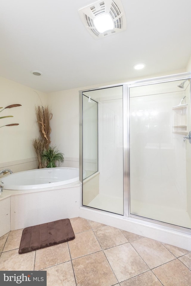 bathroom with tile patterned flooring and shower with separate bathtub