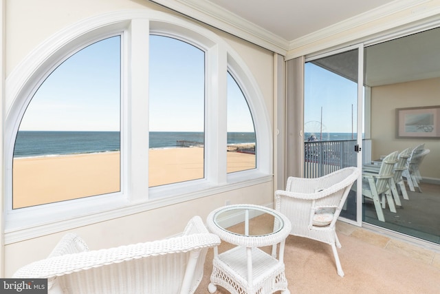 sunroom / solarium with a water view and a view of the beach