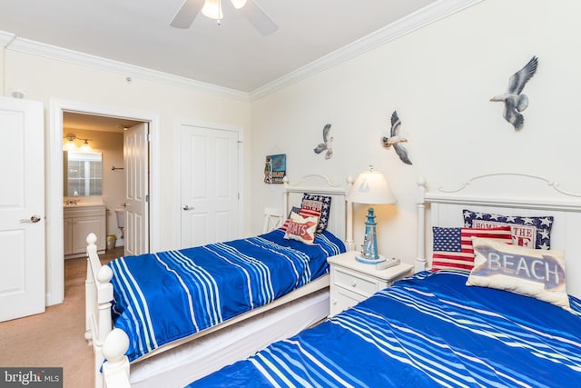 bedroom with crown molding, ceiling fan, ensuite bath, and light carpet