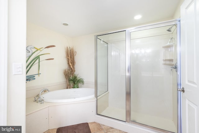 bathroom with independent shower and bath and tile patterned flooring