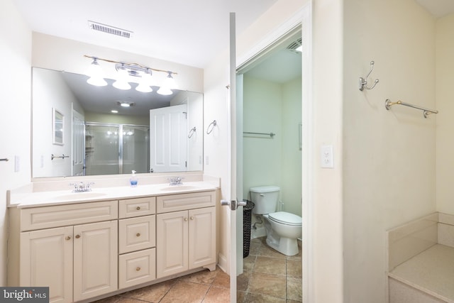 bathroom with a shower with door, vanity, and toilet