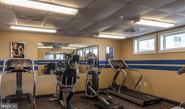 workout area with a paneled ceiling