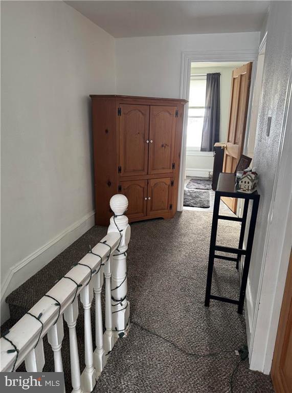 hallway featuring carpet flooring