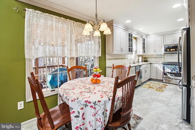 dining area featuring sink and a chandelier