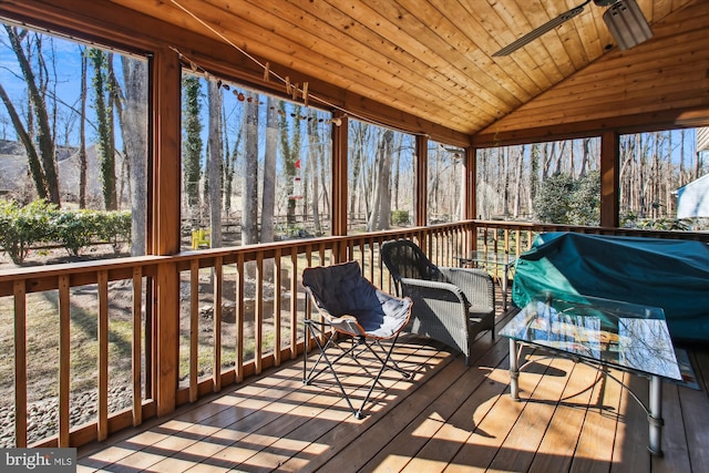 unfurnished sunroom with a wooden deck and ceiling fan