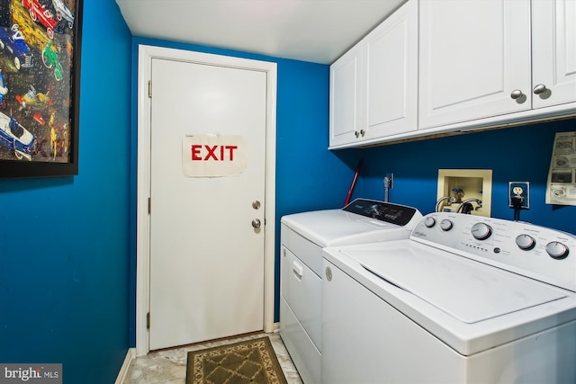 washroom with cabinets and washer and dryer