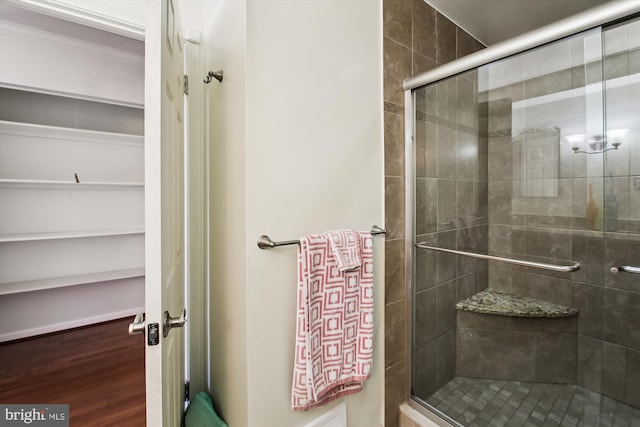 bathroom with a shower with door