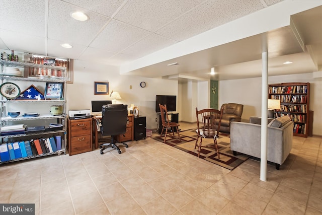 tiled home office featuring a drop ceiling