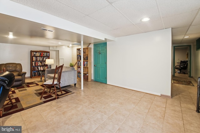 living room featuring a paneled ceiling