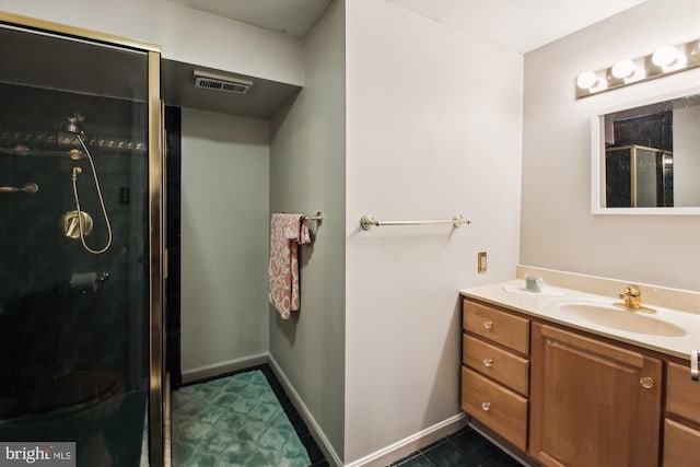 bathroom with a shower with door and vanity