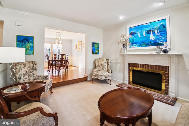 carpeted living room with an inviting chandelier, crown molding, and a fireplace